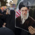 A protester hold a photograph of Ayatollah Ali Khamenei during a protest. The office of Iran’s Supreme Leader and the presidential office in Tehran were reportedly targeted in coordinated military strikes by Israel and the United States, along with military sites across the country. At least 53 people were killed at a girls’ school in the attack, according to Iranian state media reports.