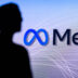 NEW YORK, USA, 1. MARCH 2022: Meta or Metaverse logo on big screen and Mark Zuckerberg silhouette. Facebook company, Meta Platforms