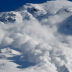 Dry snow avalanche with a powder cloud close to the village Terskol, Elbrus region